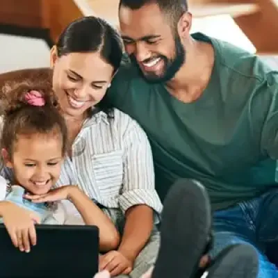 family laughing and playing in living room