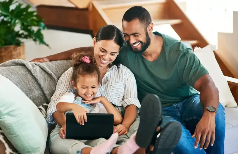 family laughing in living room, pest free home